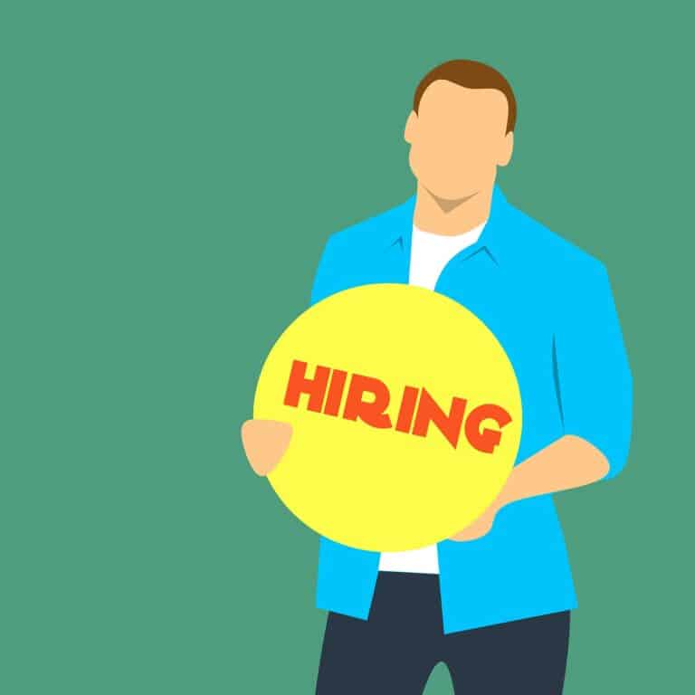 recruitment basics - man with sign saying hiring