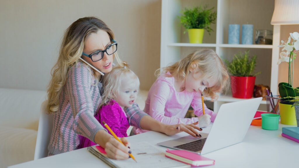 Busy Woman Trying to Work While Babysitting Two Kids