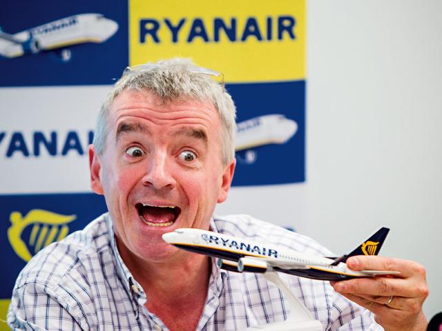 CEO Michael O'Leary holding a ryanair model plane with a open month/big smile - reviewing company culture